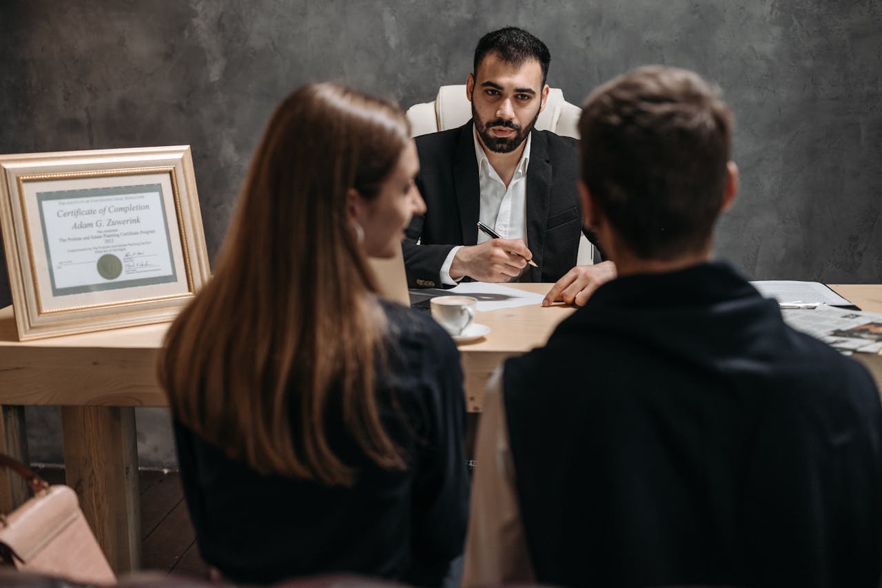 A business meeting with a professional advisor discussing documents in an office.