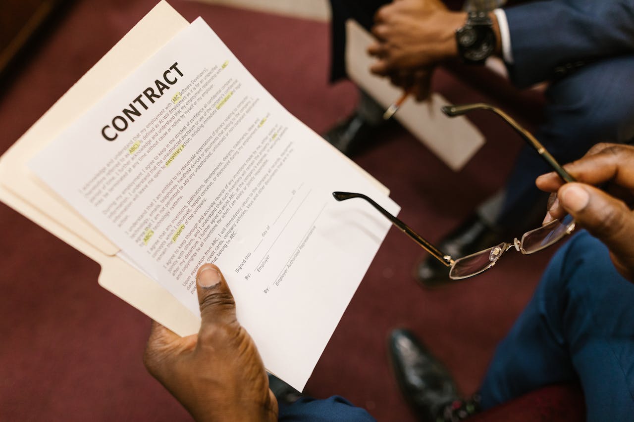 Close-up of hands holding a contract, focus on business agreement discussion.